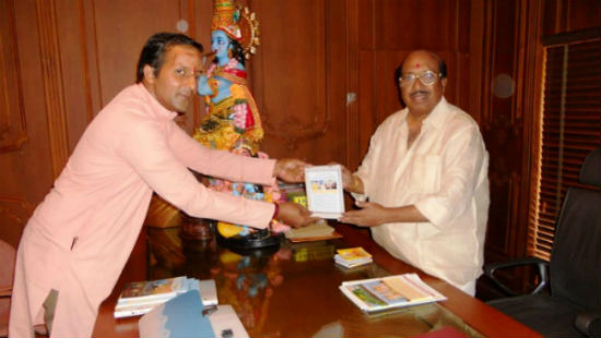 Shri. Nandkumar Kaimal of HJS presenting granth to Shri. Vellappally Nateshan
